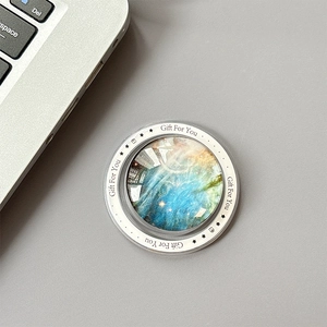 Detailed top view of a cosmic star nebula crystal ball magnetic phone grip on a desk