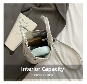 Internal view of silver mini bucket bag showing space for lipstick and makeup