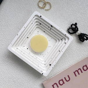 Minimalist round phone grip holder shown on a white spotted tray with aesthetic accessories
