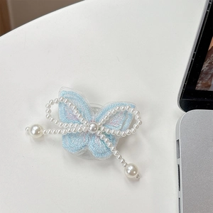 Detail of light blue embroidered butterfly phone socket with elegant pearl chain accents
