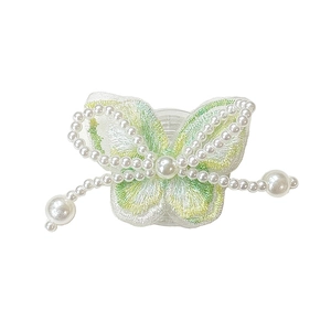 Elegant embroidered butterfly phone grip with white faux pearls on a clear base stand
