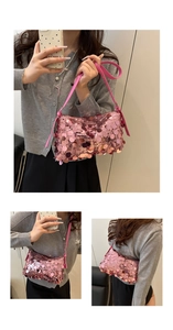 Detailed view of shimmering pink sequin shoulder bag with adjustable leather strap