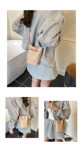 Detail of beige faux leather crossbody phone bag featuring a pebbled texture and front pocket