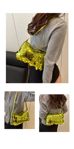 Close-up of bright yellow sequin handbag with metallic reflective texture and thin strap