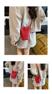 Detail of red lychee pattern leather mini bucket bag with slender shoulder strap