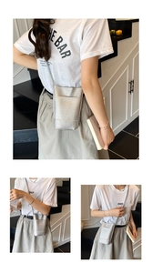 Detailed view of silver metallic textured crossbody bucket bag with outer pocket and slim strap