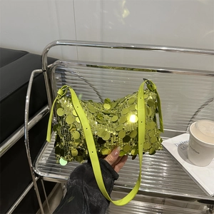 Neon green sequin pillow bag with adjustable strap and shiny disco style finish