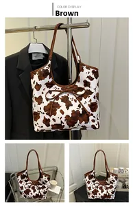 Detail of vintage cow print tote bag with brown ribbon bow in a lifestyle setting