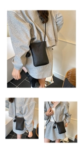 Three-way view of a black pebble leather mini crossbody bag with knot detail