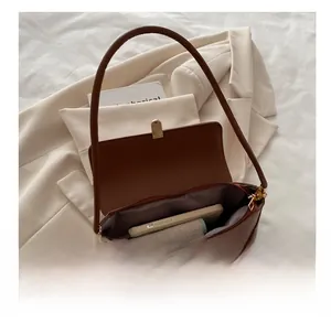 Interior view of brown leather baguette bag showing spacious storage for phone and wallet