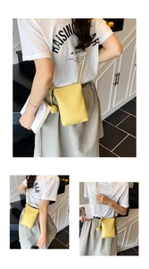 Detail of yellow lychee texture mini crossbody bucket bag with creative knot strap