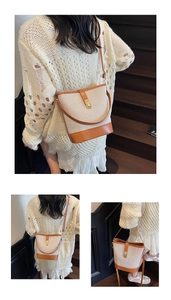 Detail view of vintage bucket bag featuring canvas and leather patchwork on model