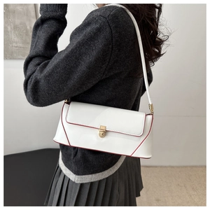 Detailed side view of white baguette bag with red edge paint and gold metal buckle