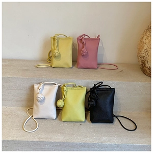 Mini crossbody bags collection in five colors with unique top knot woven ball detail