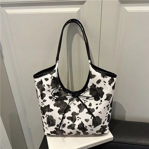 Minimalist large tote bag with black and white cow print and black bow detail