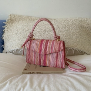 Pink striped handmade woven handbag with adjustable shoulder strap and knot handle