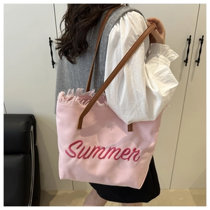 Detail of pink canvas tote with Summer embroidery and fringe edge tassel trim
