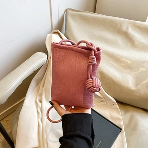 Minimalist cherry blossom pink leather crossbody bag with knot detail and shoulder strap