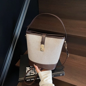 Retro canvas and brown leather bucket bag with metal buckle and shoulder strap