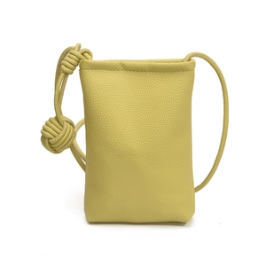 Minimalist lime green crossbody phone bag in pebble leather with stylish knot strap detail