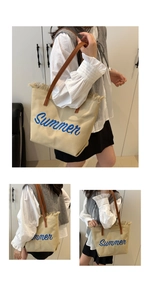 Detail of beige canvas tote bag with blue Summer embroidery and fringe trim details