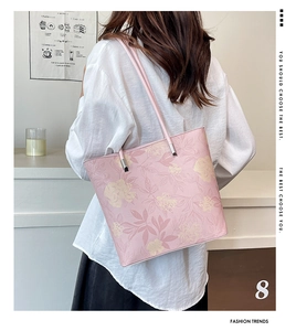 Detail of pink floral tote bag with soft yellow blossoms and a slim shoulder strap