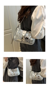 Detailed view of shiny silver sequin shoulder bag with metallic buckle and slim strap
