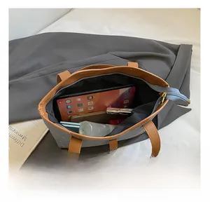 Internal view of a large tote bag showing space for a tablet, phone and cosmetics