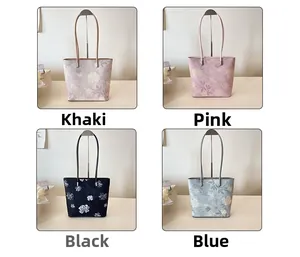 Detail view showing four color options of floral tote bags in khaki pink black and blue