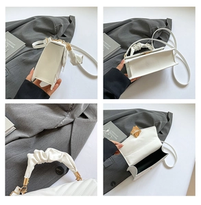 Detail view of white quilted bag with golden hardware and magnetic snap closure