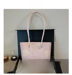 Pink floral tote bag with slender shoulder straps and premium branded gift packaging box