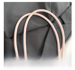 Detailed macro view of pink leather tubular handles with precise stitching on tote bag