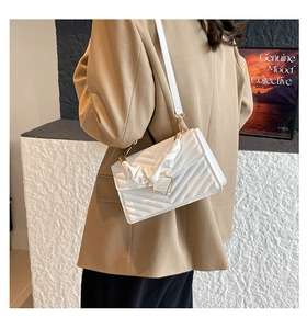 Chic white quilted crossbody bag with V-shaped stitching and pleated top handle detail
