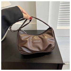 Detail of dark brown PU leather underarm bag featuring pleated design and silver zipper