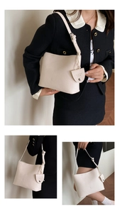 Close-up of cream leather shoulder bag detail with brand logo and adjustable strap