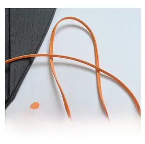 Close-up of vibrant orange PU leather shoulder strap with precise tonal stitching details