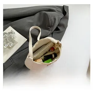 Capacity display of the cream leather baguette bag showing daily essentials inside