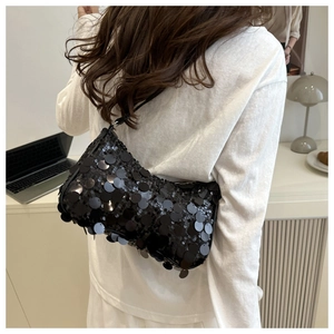 Close-up of black sequined hobo shoulder bag featuring shiny round discs and rich texture