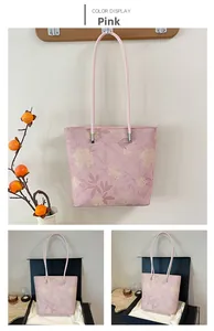 Detail view of pink floral tote bag with silver hardware and vintage flower pattern