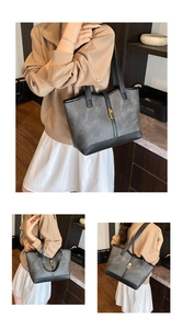 Detailed view of grey marble texture tote bag with black trim and gold clasp detail