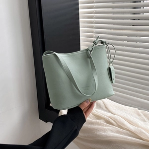 Minimalist light green litchi textured PU leather bucket bag with top handle and logo