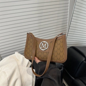 Chic brown monogram underarm bag with vintage M pattern and silver circular logo