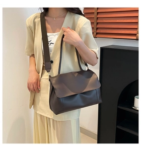 Detailed view of dark brown minimalist large tote bag with adjustable shoulder strap