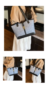 Macro detail of felt tote bag featuring grey-blue texture and gold metal buckle clasp