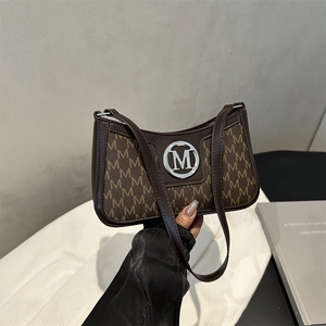Vintage brown monogram underarm bag with silver M logo and leather shoulder strap