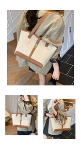 Close-up of canvas tote bag with brown leather trim and metal buckle detail