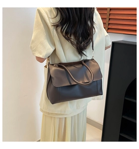 Detailed view of a dark brown large tote bag with smooth texture and adjustable strap