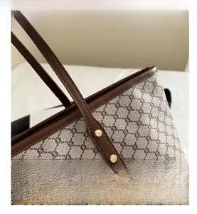 Close-up of vintage tote bag showing retro chain pattern canvas and brown leather trim