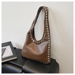 Detail view of the brown leather tote bag with silver studs and high-quality punk style finish