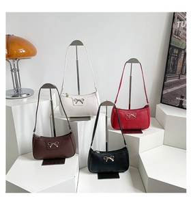 Collection of bow-tie shoulder bags in black, white, red, and brown leather